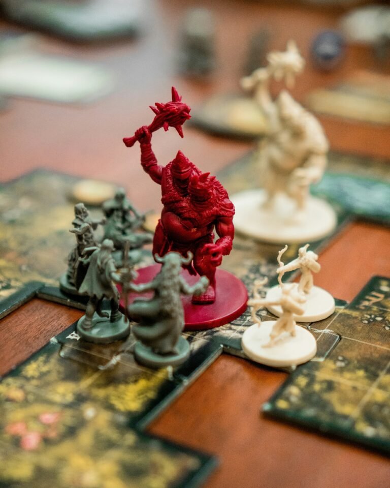 Tabletop RPG miniatures surrounding a large red monster during a Crowns and Covens TTRPG playtest combat encounter.